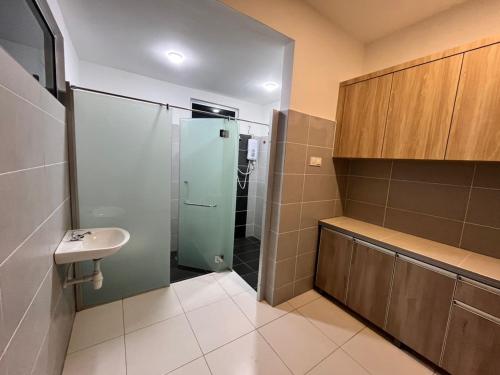 a bathroom with a shower and a sink at Exclusive Changlun Room in Bukit Kayu Hitam