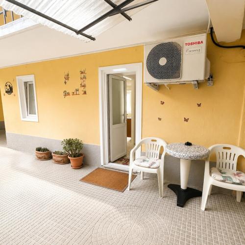 a room with two chairs and a table and a fan at Tra i laghi lago maggiore e lago d'orta in Invorio Inferiore