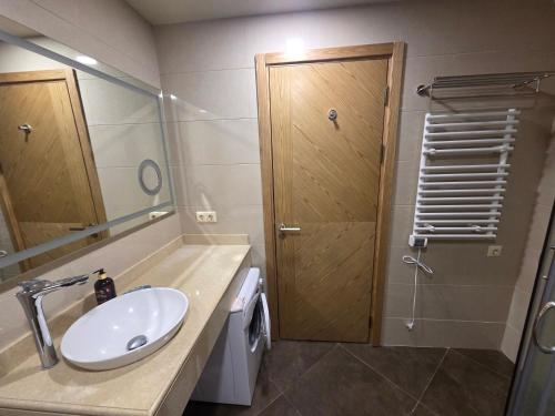 a bathroom with a sink and a shower at Luxury Oasis Apartment in Chakvi