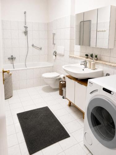a white bathroom with a washing machine in it at Riverside Ybbs - Danube View in Ybbs an der Donau