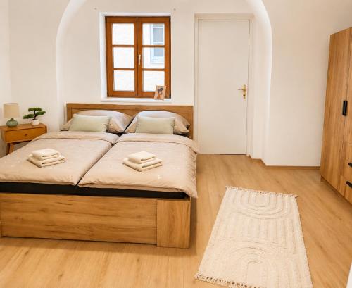 a bedroom with a large bed in a room at Riverside Ybbs - Danube View in Ybbs an der Donau