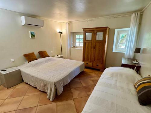 a bedroom with two beds in a room at Domaine de Villedese in Montlaur