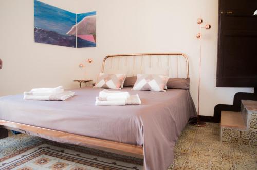 a bed with white pillows on it in a room at Chibedda Dimora Cesca in Castellammare del Golfo
