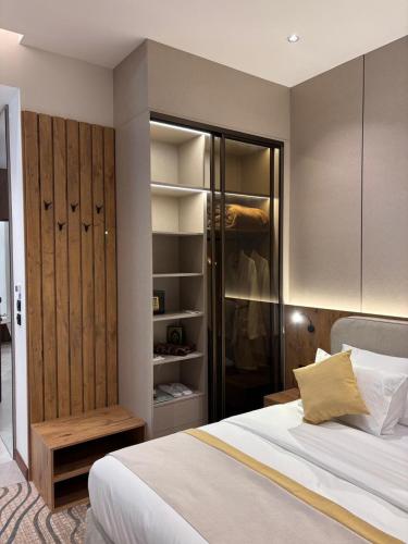 a bedroom with a bed and a closet at Voyage Expo Suites in Riyadh