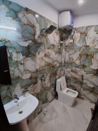 a bathroom with a sink and a toilet at Hotel Pantao Rishekesh in Rishīkesh