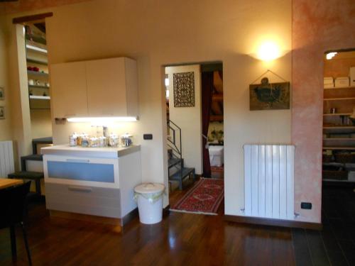 a kitchen with a counter and a door to a room at La Casina dei Piccioni in Lucca