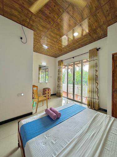 a bedroom with a large bed in a room at Nandana Homestay in Udawalawe
