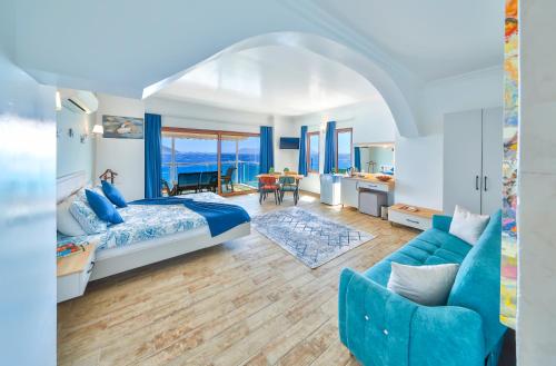 a bedroom with a blue bed and a blue couch at The Kaş Otel in Kaş