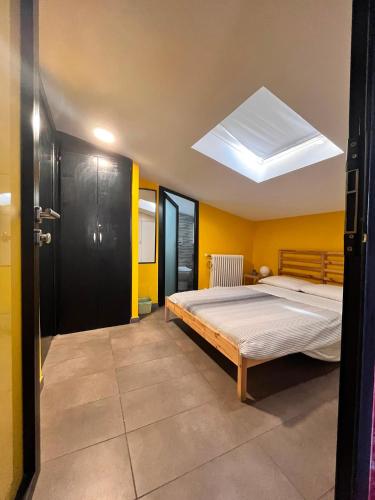 a bedroom with a bed and a skylight at Solaris Guest House in Ciampino