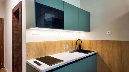 a kitchen with a sink and a microwave at Axiom Suites - Nova 4 in KoÅ¡ickÃ© KÃºpele