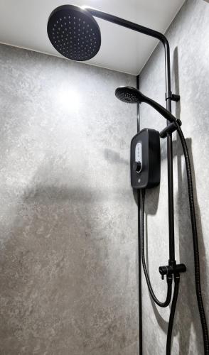 a shower with a shower head in a bathroom at The Hideout Middlesbrough Great Location in Middlesbrough