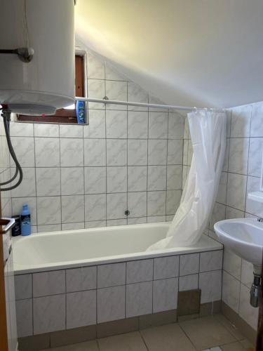 a bathroom with a bath tub and a sink at Breze Away in Tuzla