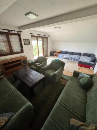 a living room with a couch and a piano at Breze Away in Tuzla