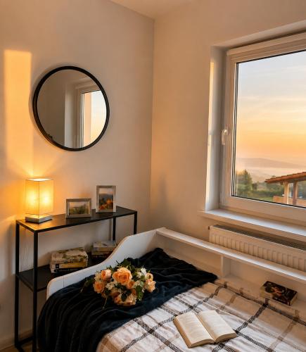 a bedroom with a bed and a window with flowers on it at Aura Home in Grywałd