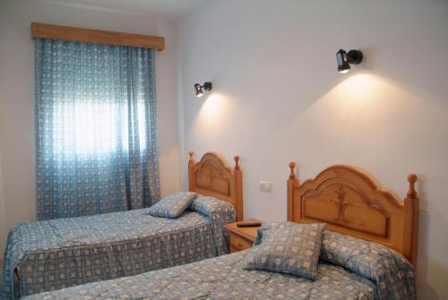 Кровать или кровати в номере Hostal Arias