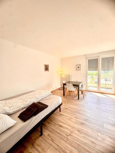 a bedroom with a bed and a desk and a table at La Résidence Urbaine in Mulhouse