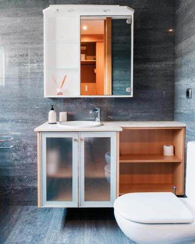 a bathroom with a white sink and a mirror at La Guardia Apartment in Póvoa de Varzim