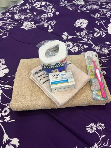 a table with a package of toothpaste and a tube of toothpaste at Private Bedroom with a private bathroom in Bolorunpelu