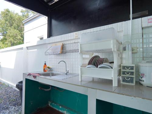 a kitchen with a sink and a counter top at MUJI House Poolvilla Pattaya in Na Jomtien