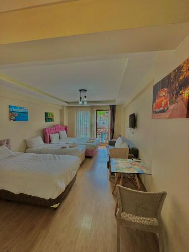 a hotel room with two beds and a living room at Green Suite in Istanbul