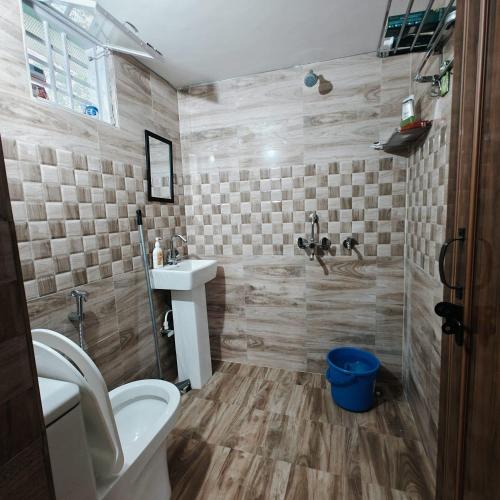 a bathroom with a toilet and a sink at Nature Nest Farms in Chūharpur