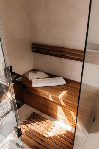 a bed in a room with a glass wall at Vershky Villas Верховина in Verkhovyna