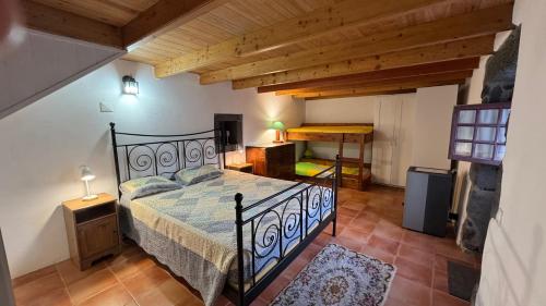 a bedroom with a bed in a room with wooden ceilings at Casa de Santana in Santana