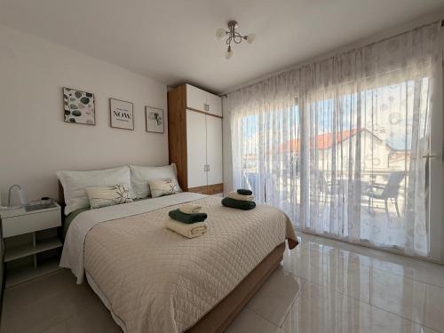 a bedroom with a bed with two towels on it at Apartments Ostojic in Krk