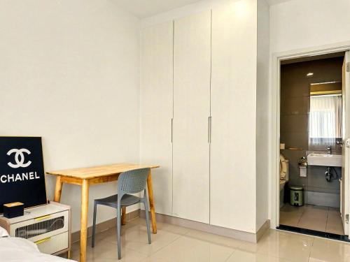 a room with a desk and a table with a chair at Modera Suites at Parkland Condo TK in Phnom Penh