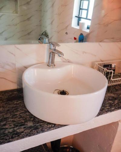 a white sink on a counter in a bathroom at Torriam Apartments in Chongwe