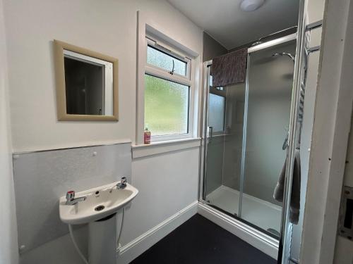 a bathroom with a sink and a shower at The Bunkhouse in Applecross