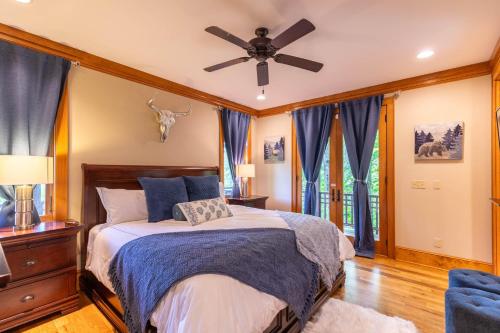 a bedroom with a bed and a ceiling fan at Headwaters Hideaway in Elk Park