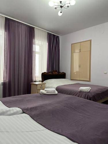 a hotel room with two beds and a mirror at Narek Home Goris in Harzhis