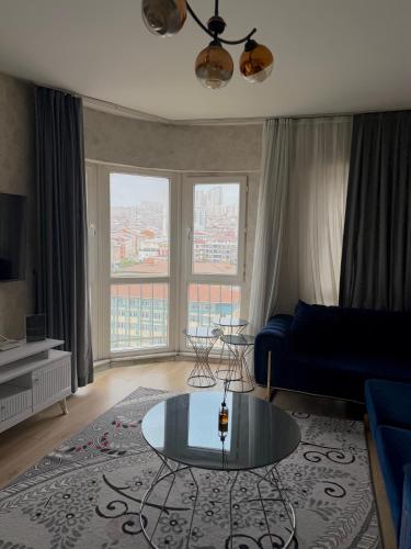a living room with a blue couch and a glass table at King Suite SS0 in Istanbul