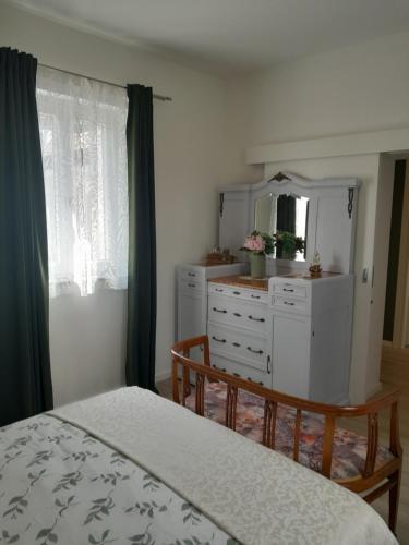 a bedroom with a bed and a dresser and a mirror at Cortile Fiorito Bed and Breakfast mini appartamento in Gorizia