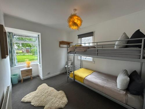 a bedroom with two bunk beds and a rug at The Bunkhouse in Applecross