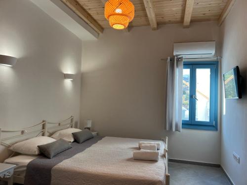 a bedroom with a bed and a window at Ramos Wellside Apartments in Serifos Chora