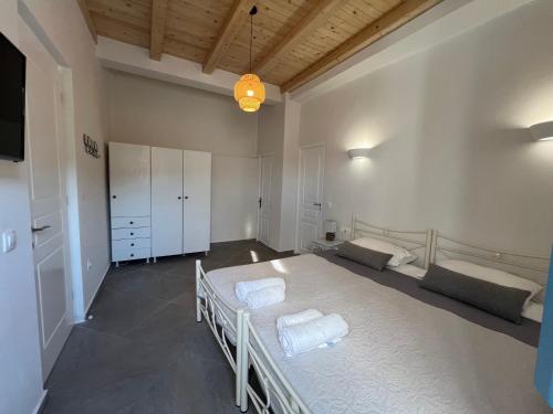 a bedroom with a large bed with towels on it at Ramos Wellside Apartments in Serifos Chora