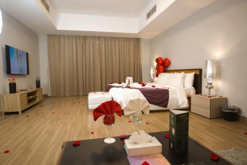 a bedroom with a bed with red balloons on the floor at Al Manzil Hotel Bahrain in Juffair