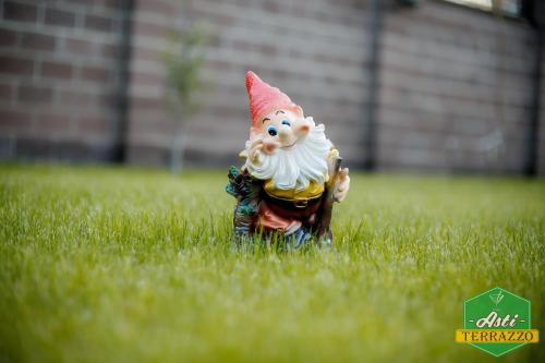 a small statue in the grass in the grass at Park Hotel in Karagandy