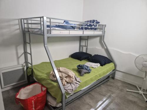 a bunk bed with clothes on it in a room at demeure du ventoux in Aubignan