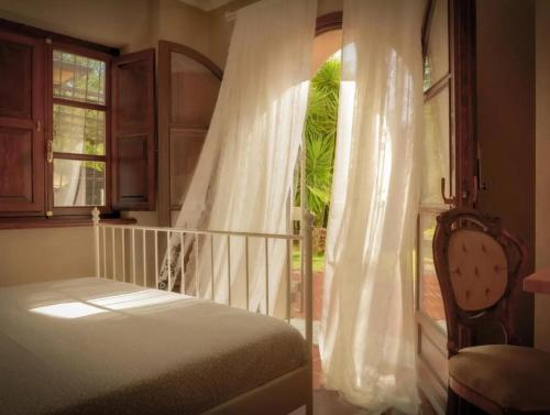a bedroom with a bed and a window at LaTorrettaLoano Affittacamere in Loano