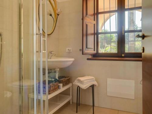 a bathroom with a sink and a glass shower at LaTorrettaLoano Affittacamere in Loano