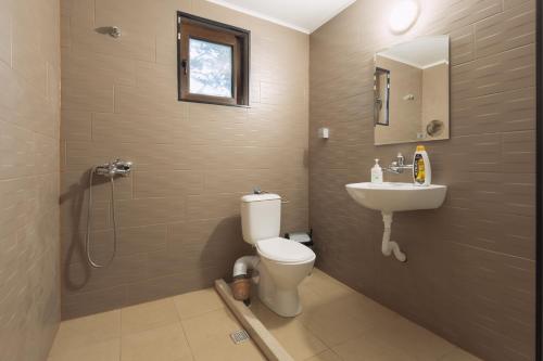 a bathroom with a toilet and a sink at Къща за гости Калабрия in Golden Sands