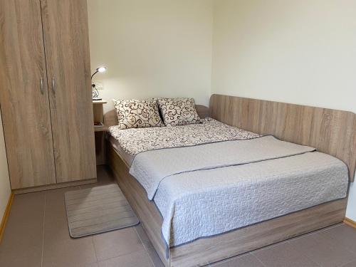 a small bed in a room with a cabinet at ATOSTOGAUTI GERA in Palanga