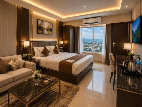 a hotel room with a bed and a couch at Hotel The Grand Villa by Signature Stayz Near International Airport in New Delhi
