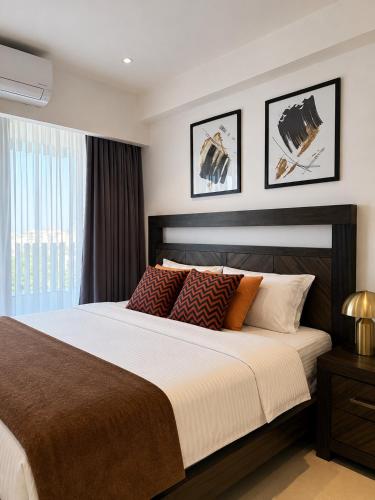 a bedroom with a large bed and a window at Luxury at Solaris Appartment in Accra