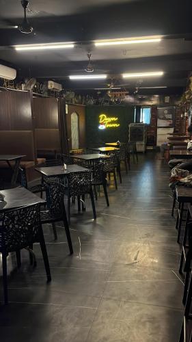 a dining room with tables and chairs in a restaurant at DownTown INN in Manendragarh