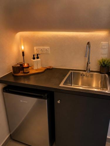 a kitchen with a sink and a counter top at VR Chora Apartments in Serifos Chora