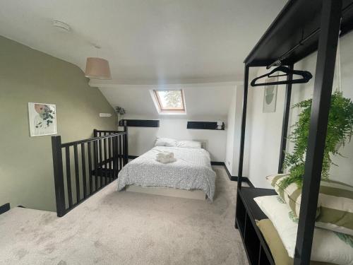 a small bedroom with a bed in a attic at Cozy House in Crookes in Walkly